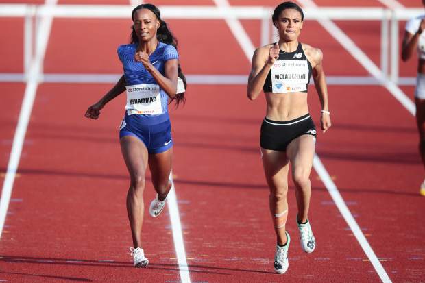 FILE - In this June 13, 2019, file photo, Dalilah Muhammad, left, and Sydney McLaughlin, both from the United States, compete in the women's 400m hurdles event at the IAAF Diamond League athletics competition in Oslo, Norway. McLaughlin took first place. McLaughlin's name constantly surfaces among the ones to watch heading into the Tokyo Games next summer. 