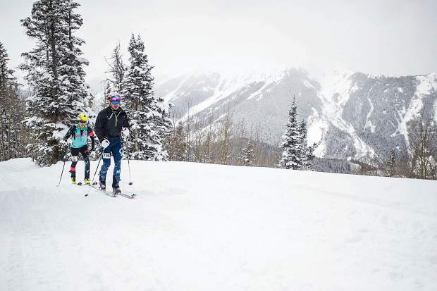 Jack Linehan, front and teammate Chris Carr skin up the backside of Aspen Mountain during the Power of Four race on Saturday.
