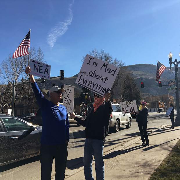 Carl Heck (left) and Mark Hesselschwerdt display signs in protest of Donald Trump on Sunday.