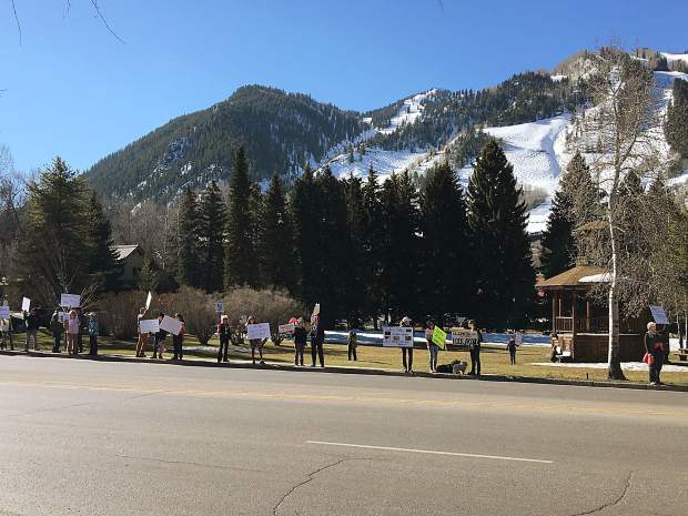 Anti-Trump protesters line Main Street in Aspen in front of Paepcke Park in Aspen on Sunday.
