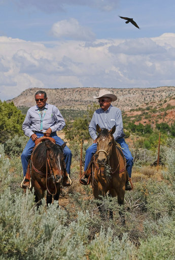 Navajo tribal members Hank Stevens, left, and Albert Holiday speak with reporters at the Butler Wash Indian Ruins trailhead after a brief visit by U.S. Interior Secretary Ryan Zinke, who is touring areas of the Bears Ears National Monument in Utah with members of the state's delegation.