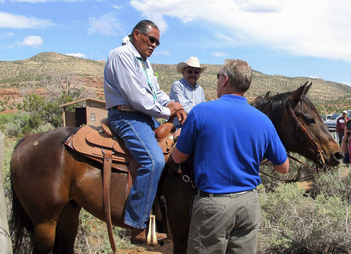 Interior Secretary Ryan Zinke, right, talks with two men on horses Monday at the Butler Wash trailhead within Bears Ears National Monument near Blanding, Utah. Zinke says he wants to make sure Native American cultural standing is preserved in a new national monument but cautioned that not all tribal members share the same opinion about it.