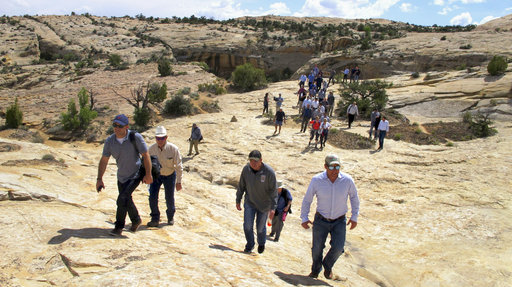 Utah state legislators and their staff lead the way for Interior Secretary Ryan Zinke, Utah Gov. Gary Herbert and others in the distance Monday through Bears Ears National Monument near Blanding, Utah.
