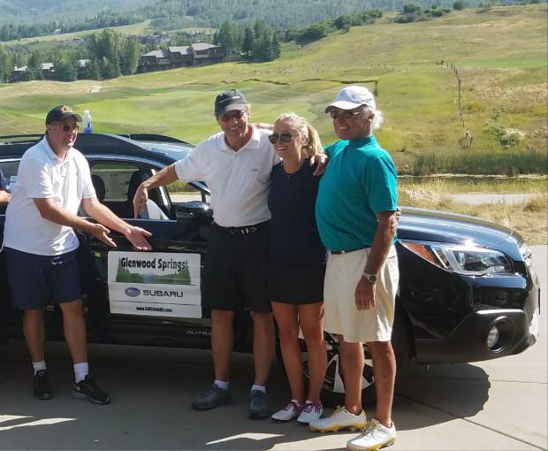 Country singer Vince Gill, left, jokes around Tuesday after Bob Devan, right, won a car with a hole-in-one at the Challenge Aspen golf fundraiser. Devan, 71, of Basalt had one of three aces register Tuesday at the Snowmass Club event, but his was the only one that gardnered a new ride.