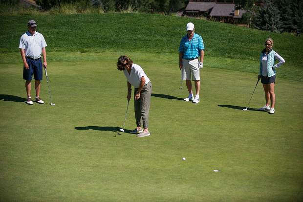 Singer Amy Grant putts at hole 7 at the Snowmass Club for the Challenge Aspen benefit known as the Vince Gill and Amy Grant 14th Anniversary Gala and Golf Classic on Tuesday.