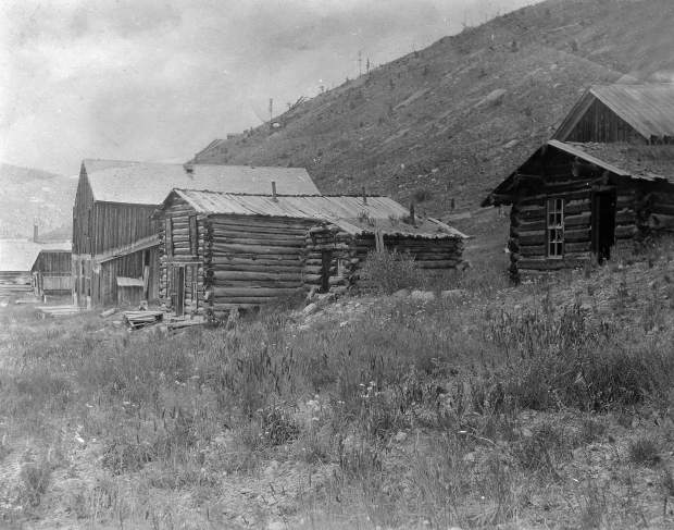 One b/w photograph of several old cabins at the ghost town of Independence, 1950-.