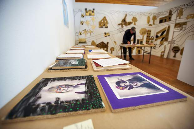 Art Installer Bill Poague hanging up the student's mural at the Art Base on November 9.
