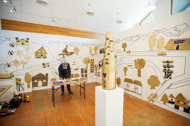 Art Installer Bill Poague hanging up the students' mural at the Art Base on November 9.