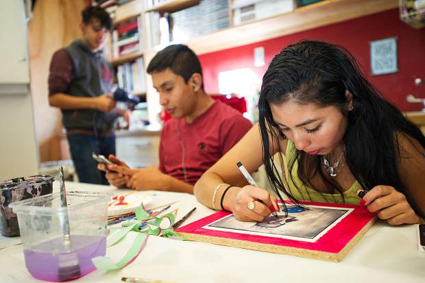 Ruth and Alex work on their self portrait portion for the mural at the Art Base on November 2.
