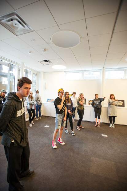 Young curators mull over artwork placement at the Aspen Art Museum on Tuesday.