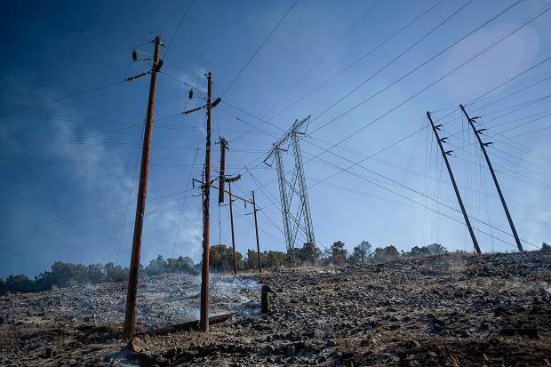 A powerline dangles and burns in the Lake Christine fire in Basalt, Colorado on July 4, 2018.