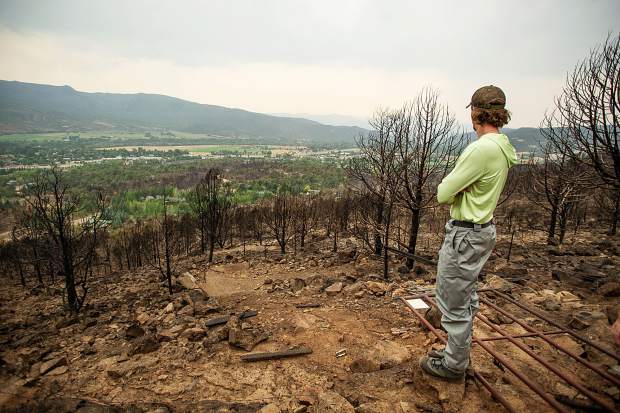 Indy Lane standing on the edge of his family's property in El Jebel that was destroyed by the Lake Christine Fire. The Lane family also encountered flash flooding from Saturday's storms creating mudslides on their property.