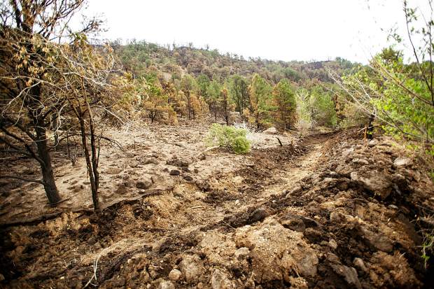 Trenches created by Cory Ross, an employee of Ace Lane's in El Jebel to help protect the property from mudslides that occurred on Saturday from rainfall on the burn scar from the Lake Christine Fire on Wednesday afternoon.