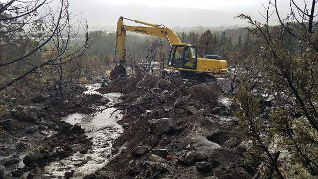 Excavating on the Lane Tree Farm property on Saturday during a storm creating a mudslide on the Lake Christine Fire burn scar.