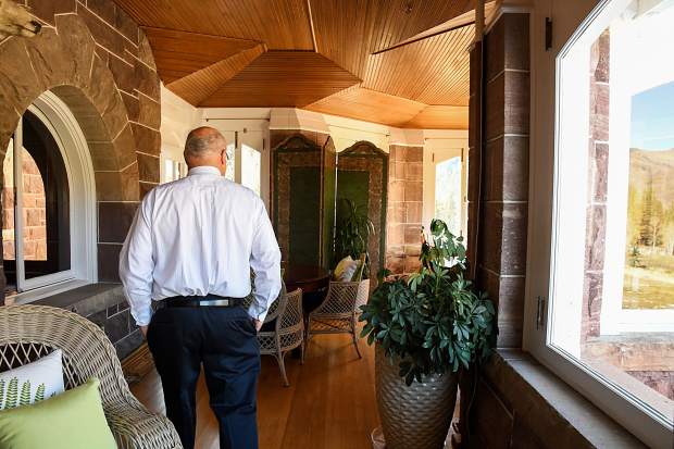 Redstone Castle owner Steve Carver walks through the sunroom of the recently restored castle during a media tour on Thursday morning.