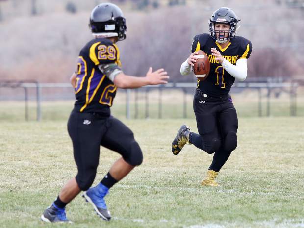 Basalt sophomore quarterback Trevor Reuss rolls to his left in the second half of a 2016 playoff game against D'Evelyn.