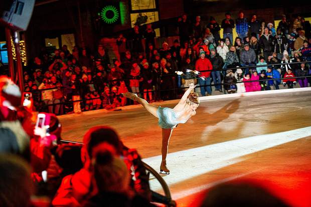 Ashley Clark performs with fire at the Snowmass Base Village grand opening Saturday night.