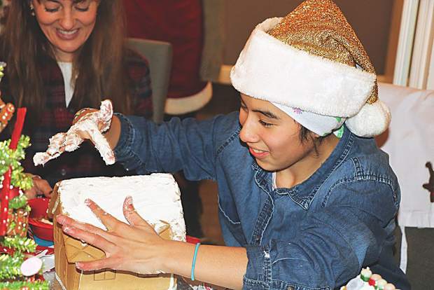 Little Buddy Jakaline works on her gingerbread house. 