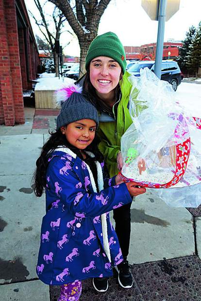 Little Buddy Debbie with Big Buddy Xan Demas depart the Aspen Gingerbread House Workshop.