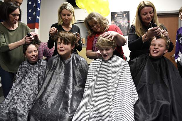 Glenwood Grizzly Bantam Hockey players, from left, Jase Joslin, Cooper Luetke, Cooper Cunningham and Hunter Oger get a little taken off the top for a good cause Thursday in Glenwood Springs. 10 out of 12 members of the team shaved their heads in honor of Cooper Cunningham’s sister Anna who is battling cancer.