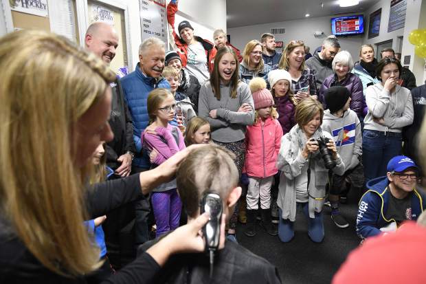 Family and friends watch as members of the Glenwood Grizzly Bantam Hockey team get their heads shaved Thursday in Glenwood Springs. The team shaved their heads for Anna Cunningham, a Basalt High School student who is battling cancer.