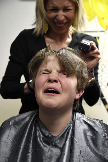 Cooper Luetke reacts after his mom Amy Luetke shaved a chunck of hair from his head Thursday in Glenwood Springs. Members of the Glenwood Grizzly Bantam Hockey team shaved heads for teammate Cooper Cunningham’s sister Anna who is battling cancer.