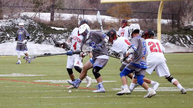 Players fight for the ball as the Aspen High School boys lacrosse team plays against Fruita Monument on Wednesday, April 3, 2019, on the AHS turf. Fruita won, 14-9. (Photo by Austin Colbert/The Aspen Times).