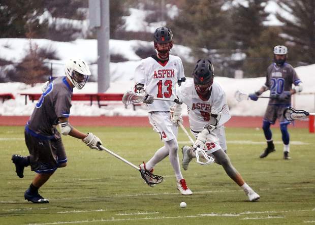 Players battle for a ground ball as the Aspen High School boys lacrosse team plays against Fruita Monument on Wednesday, April 3, 2019, on the AHS turf. Fruita won, 14-9. (Photo by Austin Colbert/The Aspen Times).