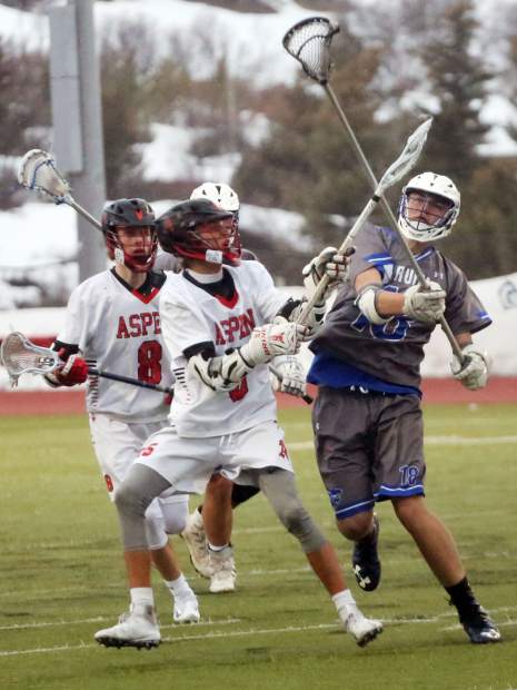 Players battle for the ball as the Aspen High School boys lacrosse team plays against Fruita Monument on Wednesday, April 3, 2019, on the AHS turf. Fruita won, 14-9. (Photo by Austin Colbert/The Aspen Times).