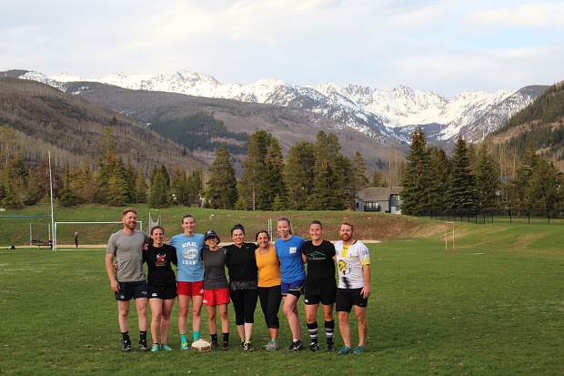 The Vail Women’s Rugby team practices with the men’s Vail Rugby team at Ford Park in Vail, with views of the Gore Range.
