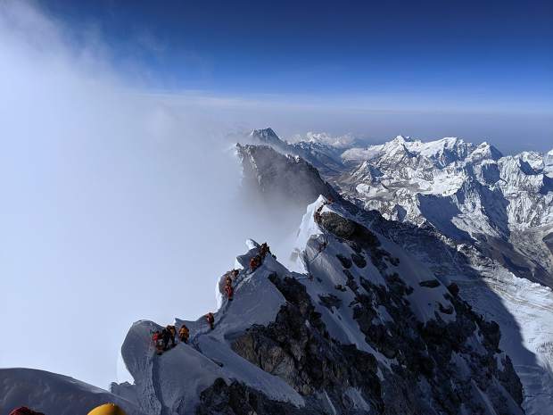 Climbers make their way to and from the South Summit in the background toward the real summit of Mount Everest. Caine said his team was able to avoid long delays reported by some parties on the final ridge.