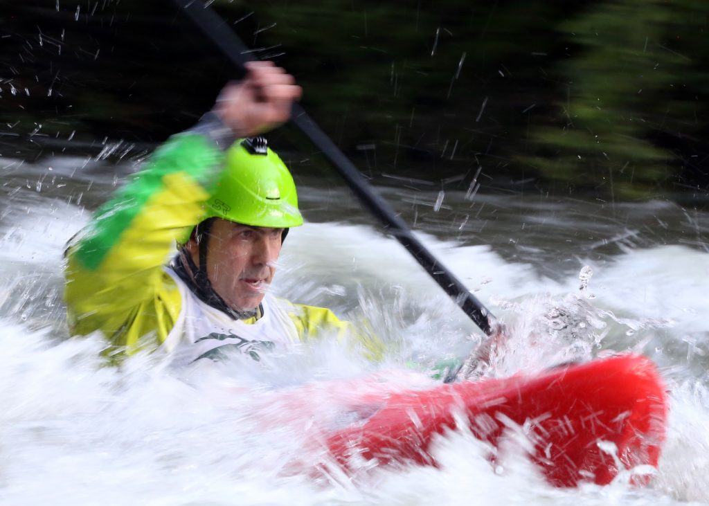 A kayaker goes through some rapids on the Roaring Fork River during the fifth annual Slaughter Fest race on Friday, July 12, 2019. The race, for kayakers, rafters or the daring stand-up paddleboarder, started at Henry Stein Park and finished at Jaffee Park in Woody Creek. (Photo by Austin Colbert/The Aspen Times)