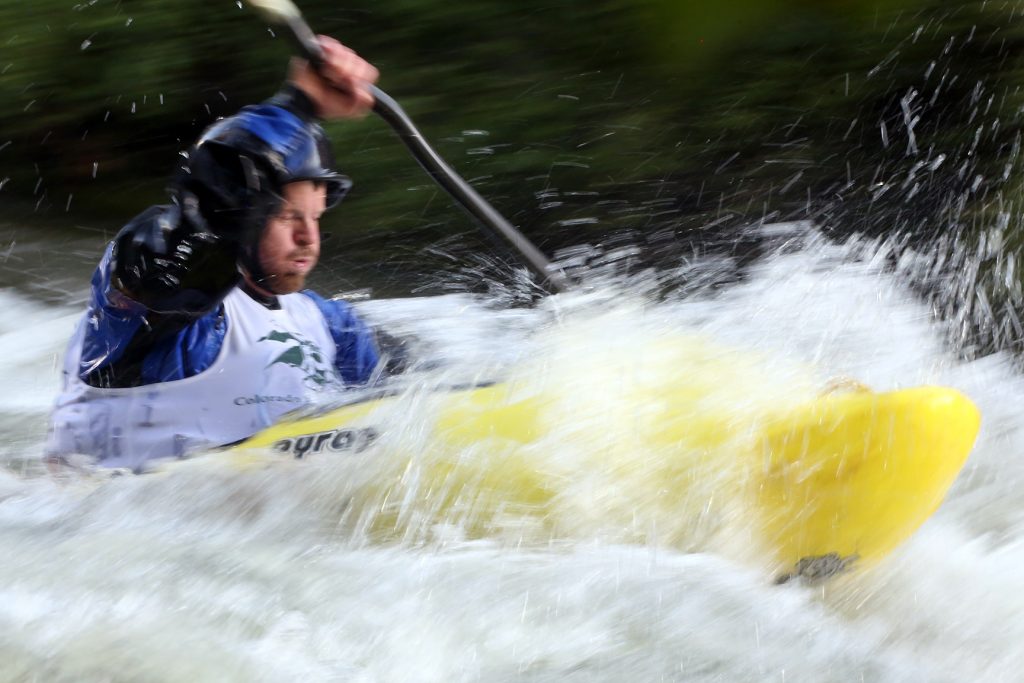 A kayaker goes through some rapids on the Roaring Fork River during the fifth annual Slaughter Fest race on Friday, July 12, 2019. The race, for kayakers, rafters or the daring stand-up paddleboarder, started at Henry Stein Park and finished at Jaffee Park in Woody Creek. (Photo by Austin Colbert/The Aspen Times)