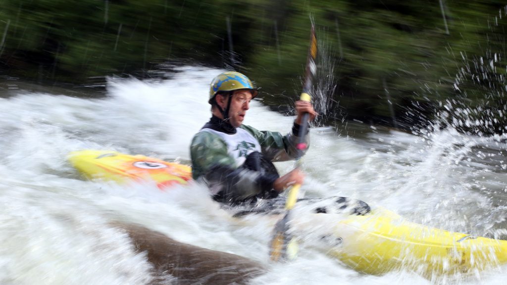 A kayaker goes through some rapids on the Roaring Fork River during the fifth annual Slaughter Fest race on Friday, July 12, 2019. The race, for kayakers, rafters or the daring stand-up paddleboarder, started at Henry Stein Park and finished at Jaffee Park in Woody Creek. (Photo by Austin Colbert/The Aspen Times)