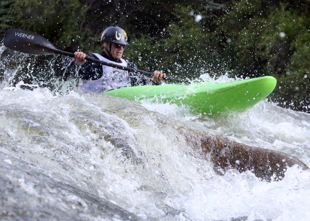 A kayaker goes through some rapids on the Roaring Fork River during the fifth annual Slaughter Fest race on Friday, July 12, 2019. The race, for kayakers, rafters or the daring stand-up paddleboarder, started at Henry Stein Park and finished at Jaffee Park in Woody Creek. (Photo by Austin Colbert/The Aspen Times)