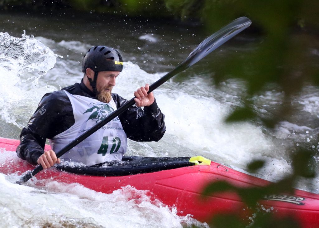 A kayaker goes through some rapids on the Roaring Fork River during the fifth annual Slaughter Fest race on Friday, July 12, 2019. The race, for kayakers, rafters or the daring stand-up paddleboarder, started at Henry Stein Park and finished at Jaffee Park in Woody Creek. (Photo by Austin Colbert/The Aspen Times)