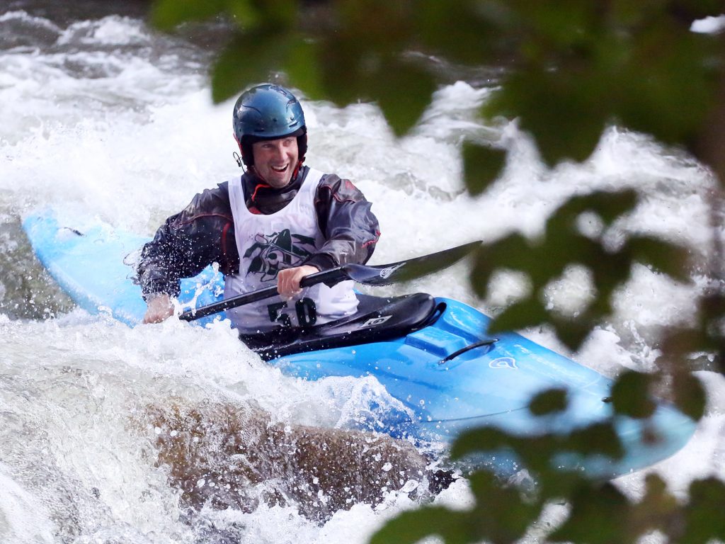 A kayaker goes through some rapids on the Roaring Fork River during the fifth annual Slaughter Fest race on Friday, July 12, 2019. The race, for kayakers, rafters or the daring stand-up paddleboarder, started at Henry Stein Park and finished at Jaffee Park in Woody Creek. (Photo by Austin Colbert/The Aspen Times)