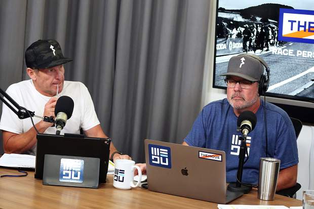 Lance Armstrong, left, and JB Hager listen as George Hincapie (not pictured) talks during 