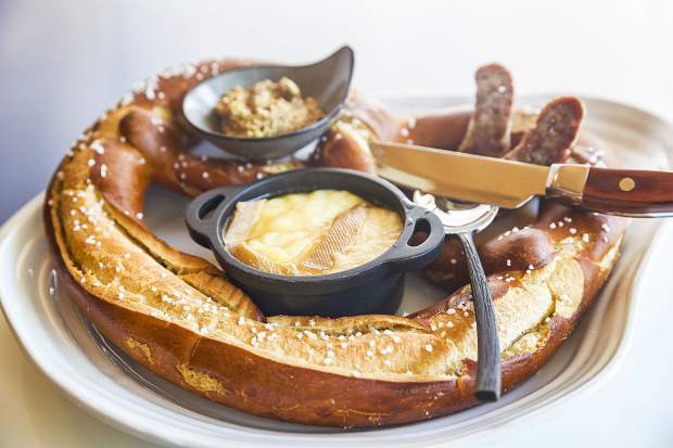 A Bavarian pretzel with accoutrements made for sharing.