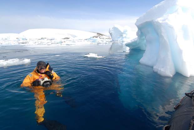 Photographer and filmmaker Pete McBride surfaces and tries to smile through numb lips while diving in Antarctica.