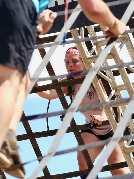 An athlete climbs the A-frame cargo net on Saturday, Aug. 3, 2019, during the first-ever Spartan obstacle-course race in Snowmass. (Photo by Austin Colbert/The Aspen Times)