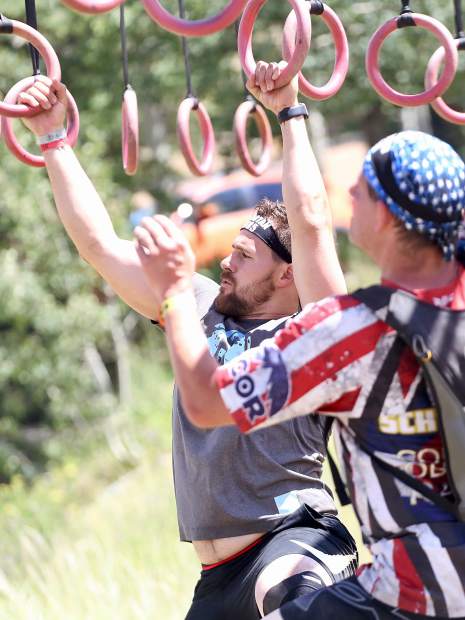Athletes make their way across the multi-rig on Saturday, Aug. 3, 2019, during the first-ever Spartan obstacle-course race in Snowmass. (Photo by Austin Colbert/The Aspen Times)