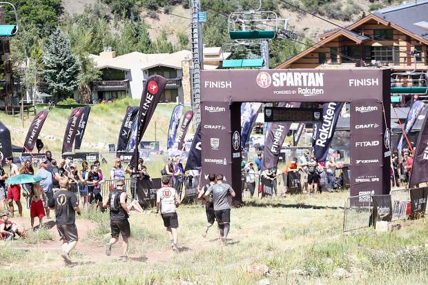 Athletes reach the finish line on Saturday, Aug. 3, 2019, during the first-ever Spartan obstacle-course race in Snowmass. (Photo by Austin Colbert/The Aspen Times)