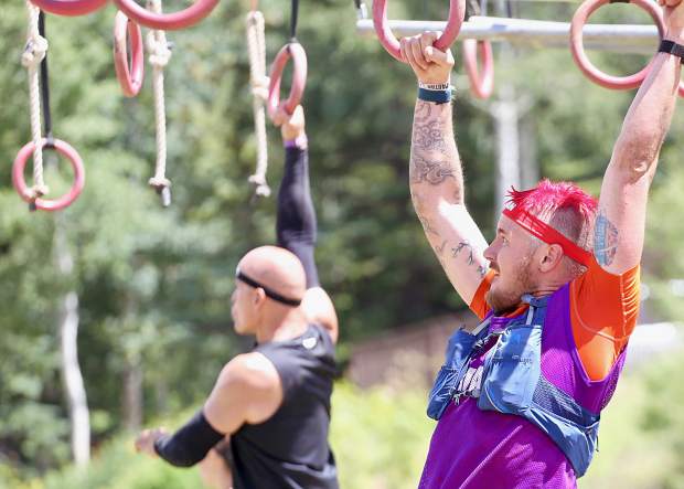 Athletes make their way across the multi-rig on Saturday, Aug. 3, 2019, during the first-ever Spartan obstacle-course race in Snowmass. (Photo by Austin Colbert/The Aspen Times)
