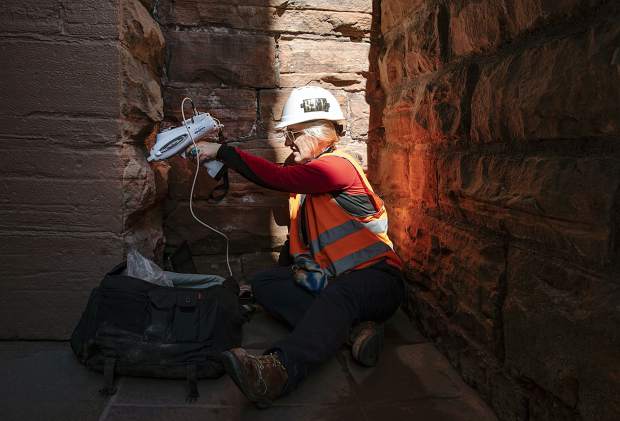 Architectural conservator Natalie Feinberg Lopez uses a XRF Spectrometer on the stonework of the Wheeler Opera House on Tuesday, September 17, 2019. The spectrometer performs an elemental analysis on the stone. Feinberg Lopez is testing areas that she cleaned with seven different cleaners three months ago to see which was most effective and the most gentle. (Kelsey Brunner/The Aspen Times)