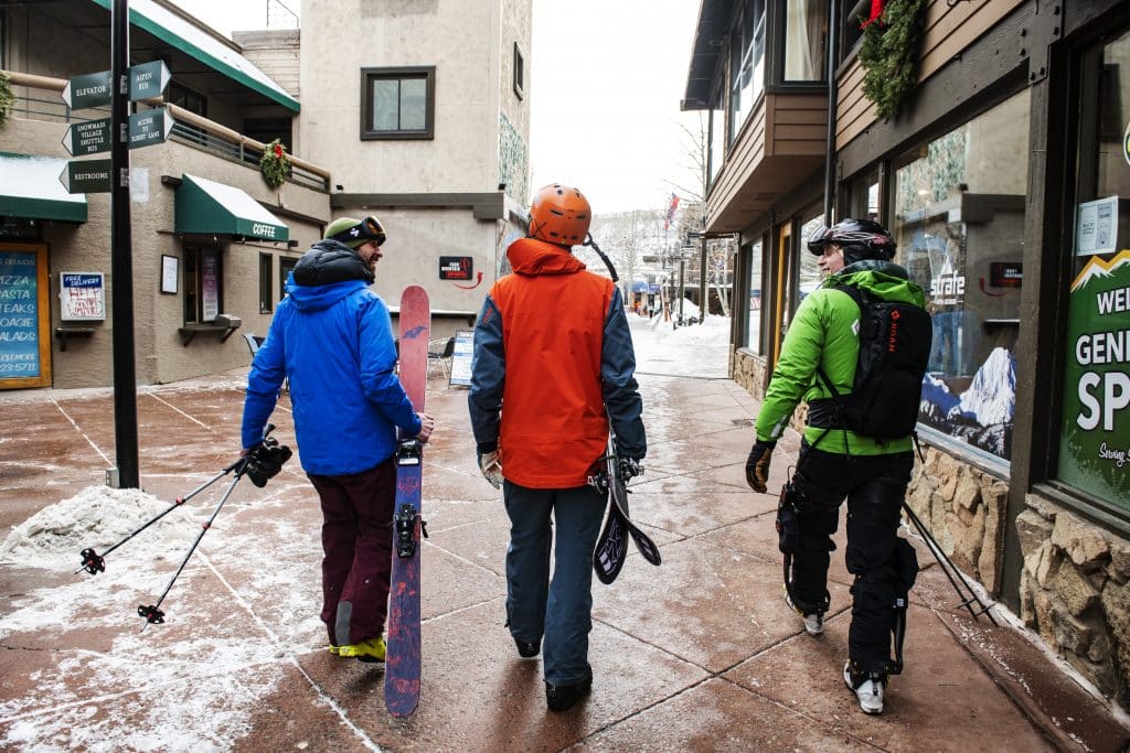 ROAM Director of Marketing Johnny Kern, left, Spencer Miller, and Jim Harris walk through the Village Mall in Snowmass on Friday, Jan. 31, 2020. Harris tried the Elevate exoskeleton from ROAM Robotics for the second time. The exoskeleton makes him feel like there’s more of a possibility to keep up with friends. Harris said that before his accident skiing was his income, how he maintained friendships and both the activity he did for work and fun. He explained that after his accident his entire life was upside down, which included his ability to ski. (Kelsey Brunner/The Aspen Times)