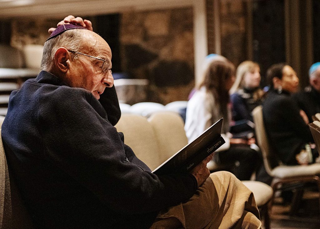A man reading prayers during a Friday night Shabbat service at the Aspen Chapel.