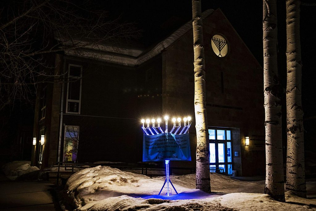 A menorah glows outside of the Aspen Jewish Community Center on a Saturday evening.