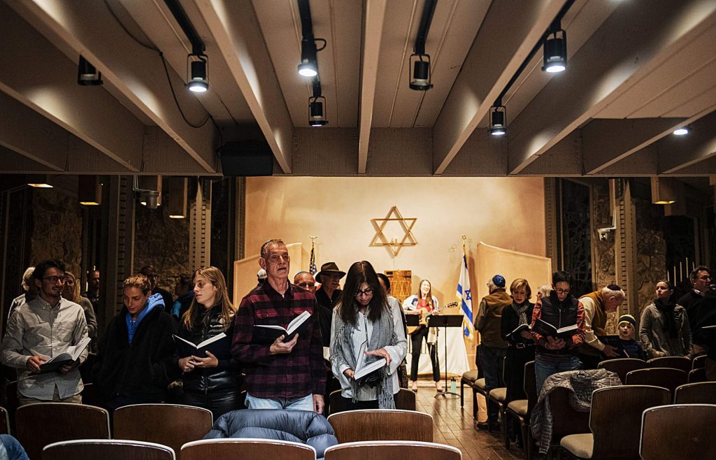 A congregation sings during a Friday night Shabbat service at the Aspen Chapel.