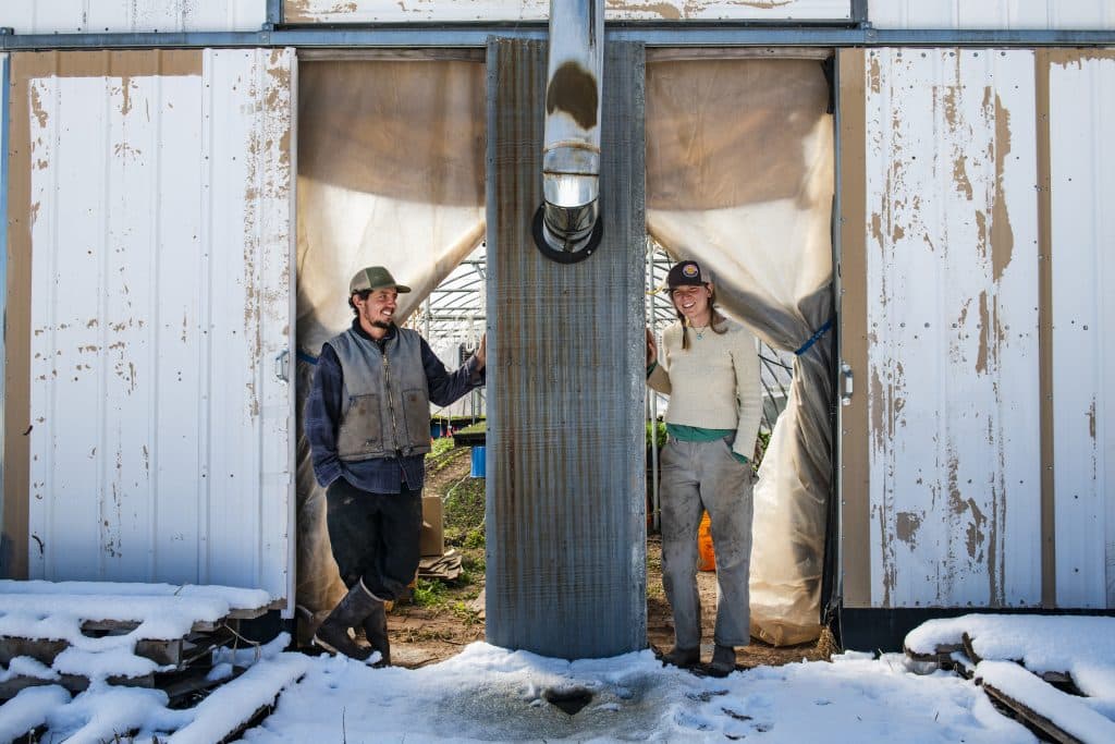 Wild Mountain Seeds farmers Casey Piscura, left, and partner Kirsten Keenan stand in the doorway of one of their greenhouses in Carbondale on Thursday, April 2, 2020. The two have had Wild Mountain Seeds for seven years and Piscura explained that every year they want to produce more food. 